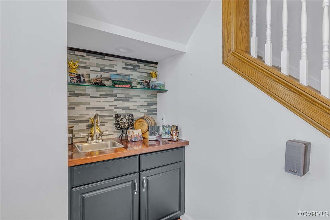 1843 Fairport Road Reedville, VA 22539 - Photo 41 of 43 Bar with backsplash, gray cabinets, and sink