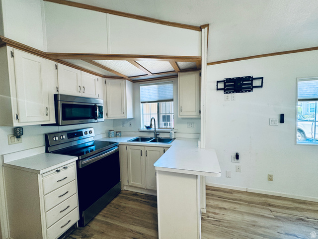 150 North 3050 East, Unit 4 St. George, UT 84790 - Photo 9 of 24 Kitchen featuring wood-finish flooring and white cabinetry