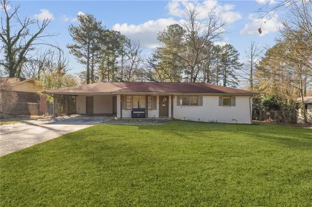 a front view of a house with a garden