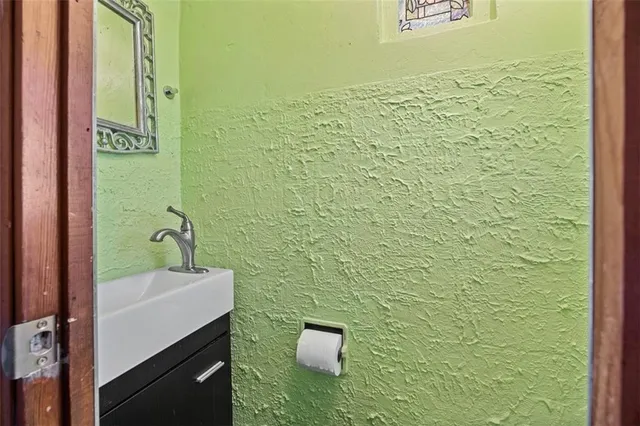 a bathroom with a sink a toilet and mirror