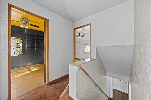 hallway with wooden floor and dining room view