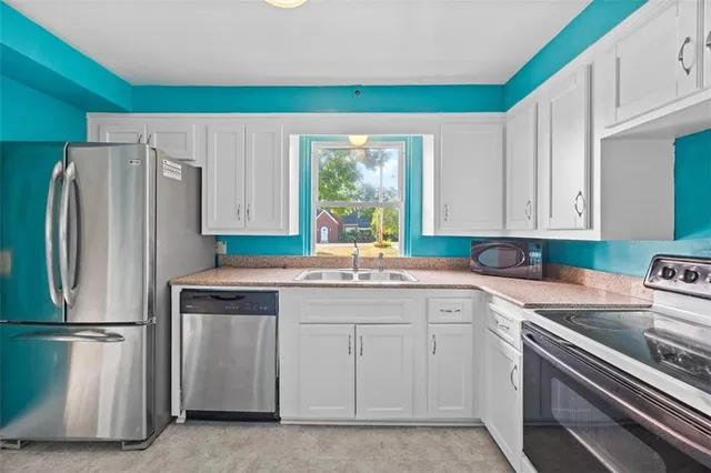 a kitchen with a white cabinets and white appliances