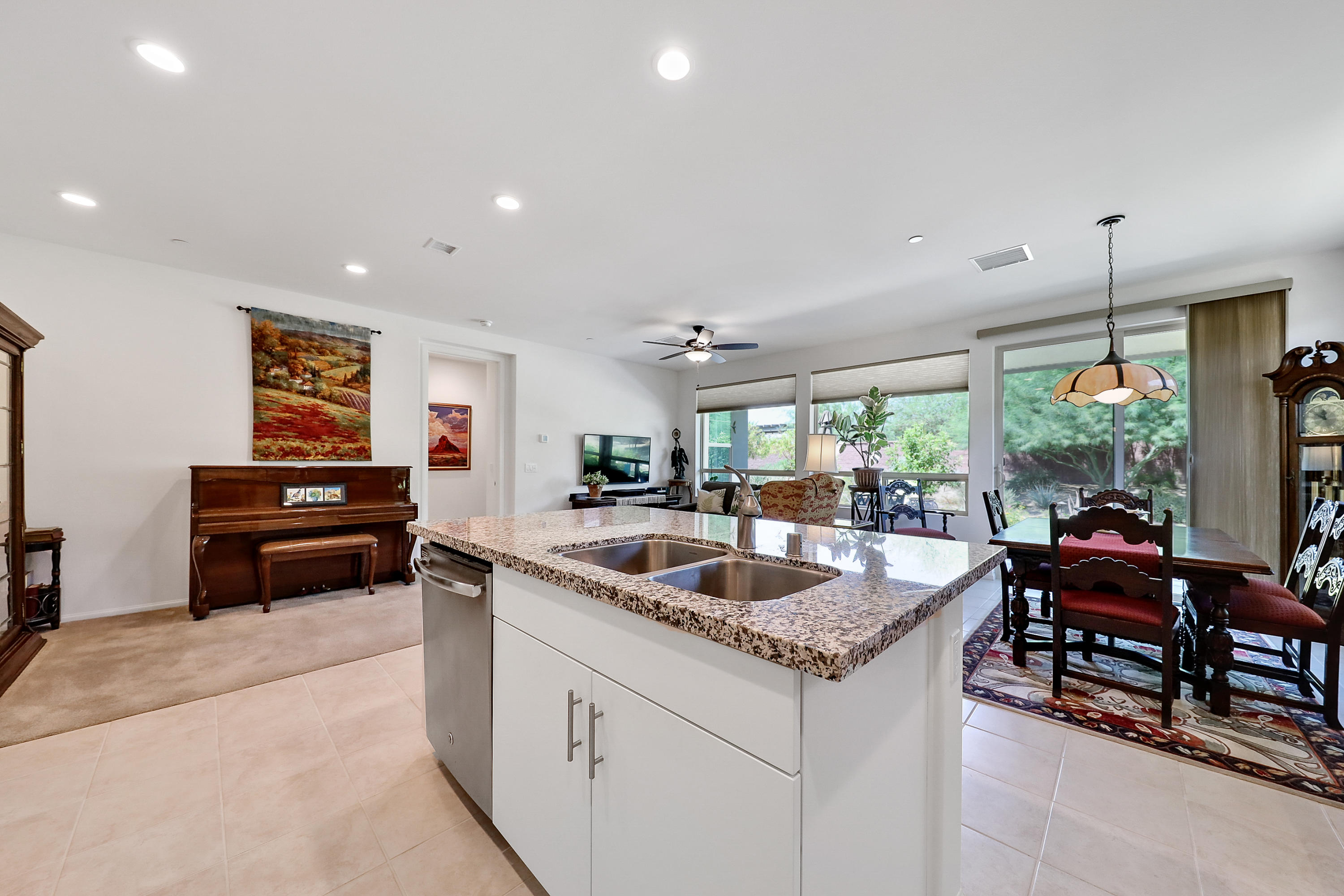 51731 Golden Eagle Drive Indio, CA 92201 - Photo 7 of 28 a kitchen with granite countertop a sink and a dining table