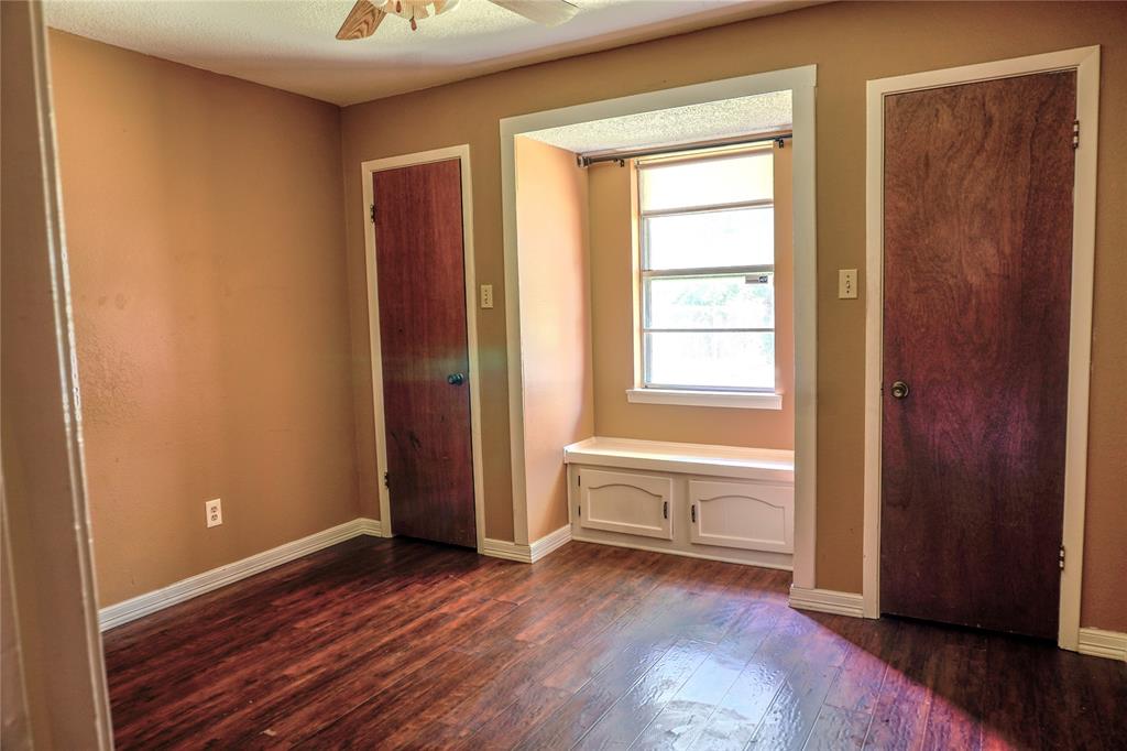 300 Coury Road Everman, TX 76140 - Photo 17 of 29 a view of an empty room with wooden floor and a window