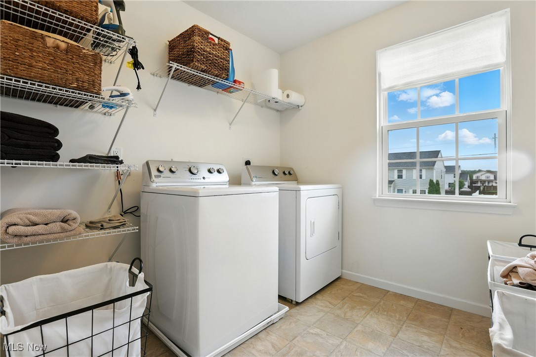 2112 Fowl Road Elyria, OH 44035 - Photo 32 of 49 Laundry room featuring separate washer and dryer and baseboards