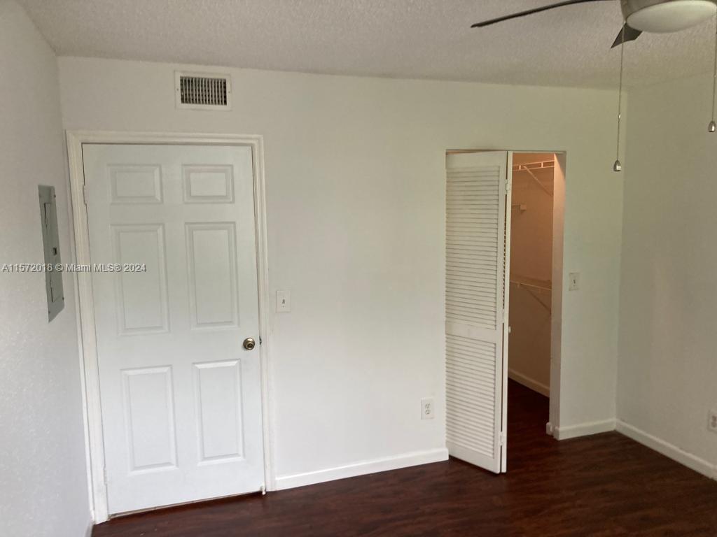 3985 West McNab Road, Unit A111 Pompano Beach, FL 33069 - Photo 14 of 36 a view of an empty room with wooden floor
