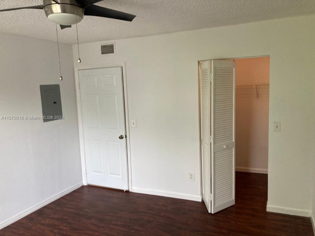 3985 West McNab Road, Unit A111 Pompano Beach, FL 33069 - Photo 16 of 36 a view of empty room with wooden floor