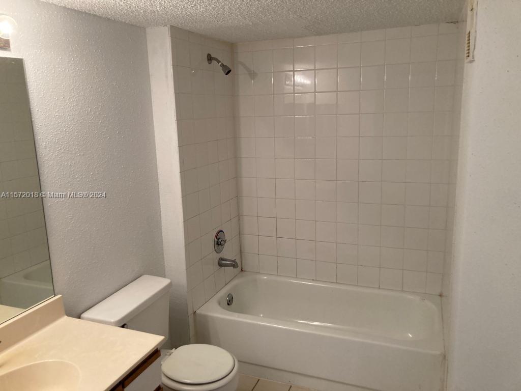 3985 West McNab Road, Unit A111 Pompano Beach, FL 33069 - Photo 18 of 36 a bathroom with a toilet and a bath tub