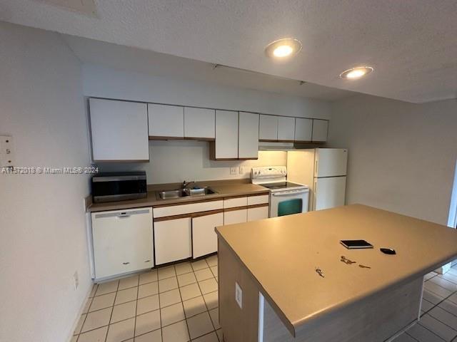 3985 West McNab Road, Unit A111 Pompano Beach, FL 33069 - Photo 2 of 36 a kitchen with a sink a stove and refrigerator