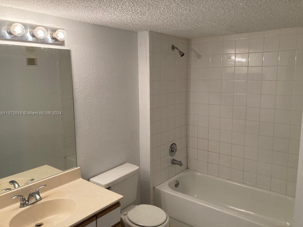 3985 West McNab Road, Unit A111 Pompano Beach, FL 33069 - Photo 21 of 36 a bathroom with a sink and a bathtub