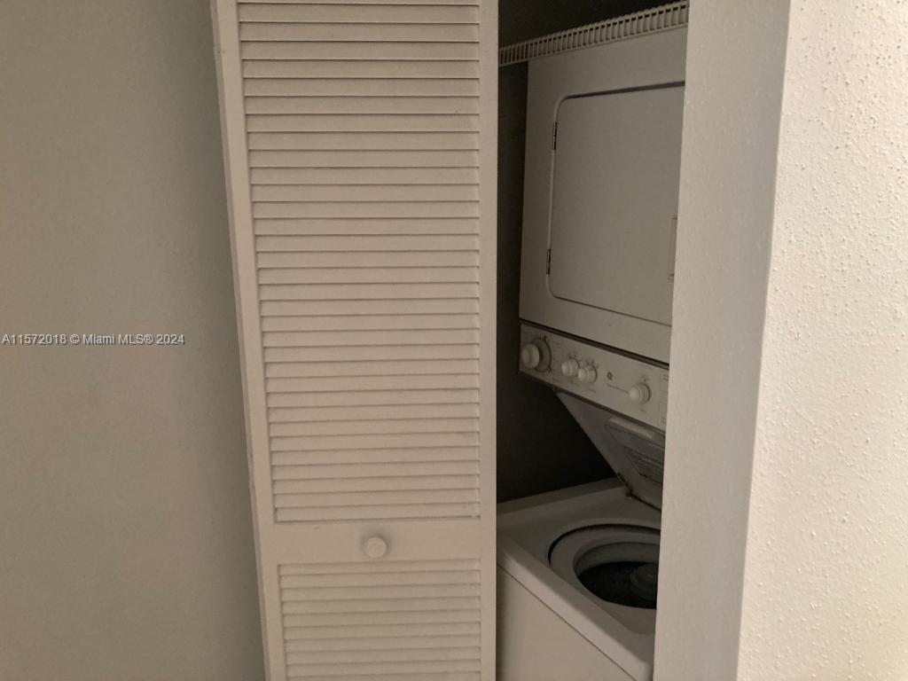 3985 West McNab Road, Unit A111 Pompano Beach, FL 33069 - Photo 22 of 36 a close view of a utility room with dryer and washer