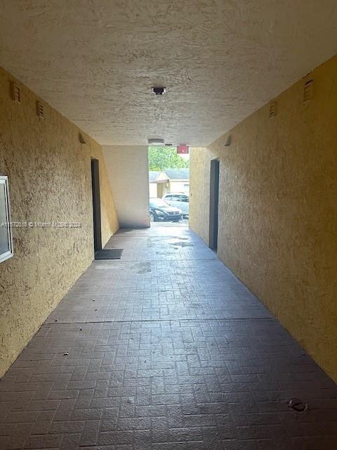 3985 West McNab Road, Unit A111 Pompano Beach, FL 33069 - Photo 23 of 36 a view of a hallway with a window