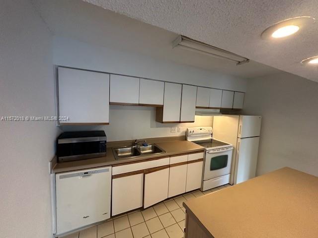 3985 West McNab Road, Unit A111 Pompano Beach, FL 33069 - Photo 24 of 36 a kitchen with granite countertop a sink a stove and refrigerator