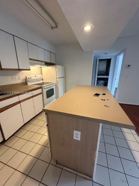 3985 West McNab Road, Unit A111 Pompano Beach, FL 33069 - Photo 25 of 36 a kitchen with stainless steel appliances a stove a sink a refrigerator and cabinets