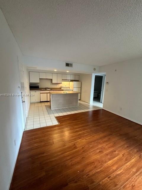 3985 West McNab Road, Unit A111 Pompano Beach, FL 33069 - Photo 27 of 36 a room with wooden floors and view