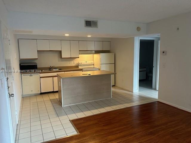 3985 West McNab Road, Unit A111 Pompano Beach, FL 33069 - Photo 28 of 36 a kitchen with stainless steel appliances granite countertop a stove a sink and a refrigerator