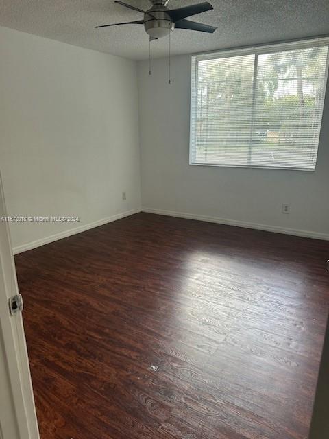 3985 West McNab Road, Unit A111 Pompano Beach, FL 33069 - Photo 29 of 36 an empty room with wooden floor and windows