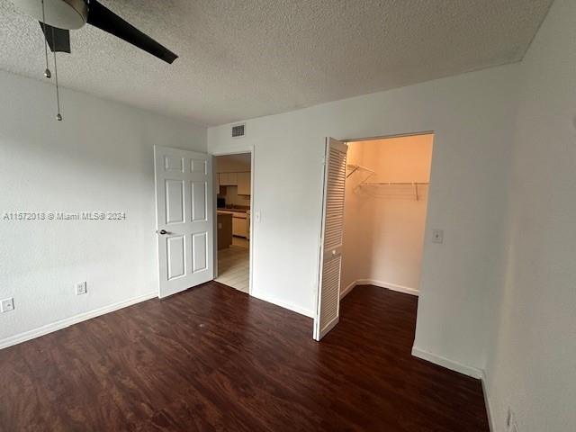 3985 West McNab Road, Unit A111 Pompano Beach, FL 33069 - Photo 30 of 36 an empty room with wooden floor cabinet and closet