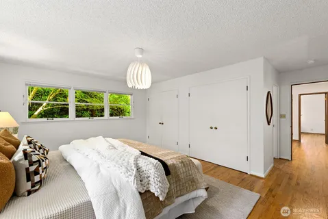 a bedroom with a large bed and a window