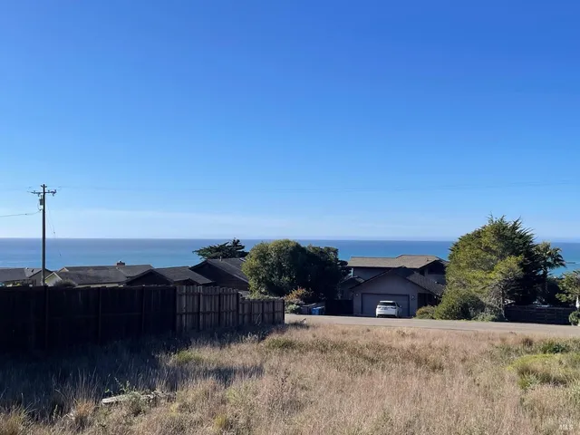 a view of a lake with a house in the background