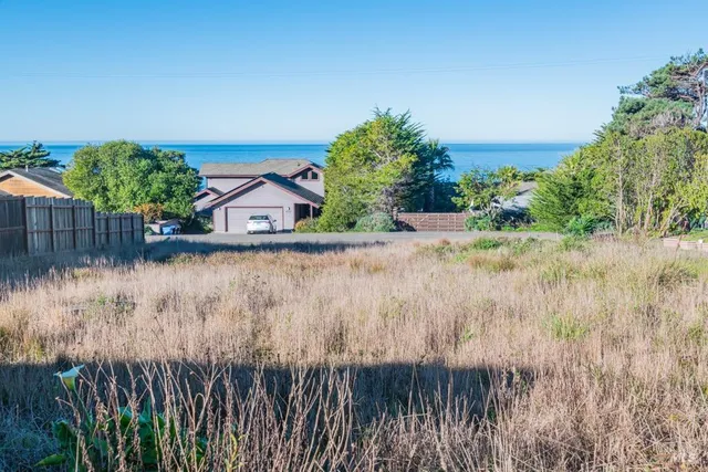 a view of a wooden fence next to a lake