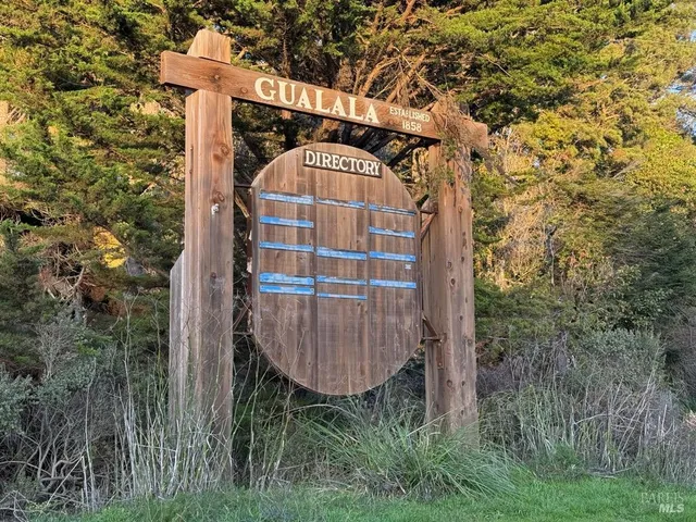 a view of a wooden door with a tree in the background