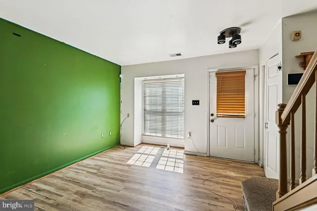 a view of a room with wooden floor and windows
