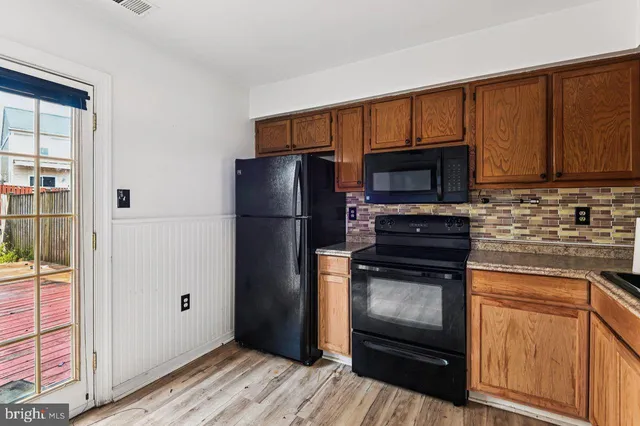 a kitchen with a refrigerator stove and cabinets