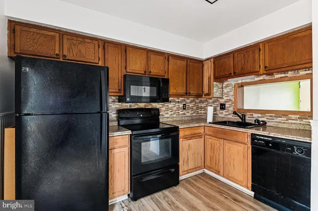 a kitchen with stainless steel appliances granite countertop a refrigerator stove and microwave