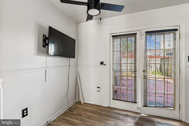 a view of a livingroom with wooden floor and windows