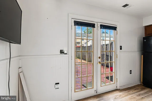 a view of front door with wooden floor