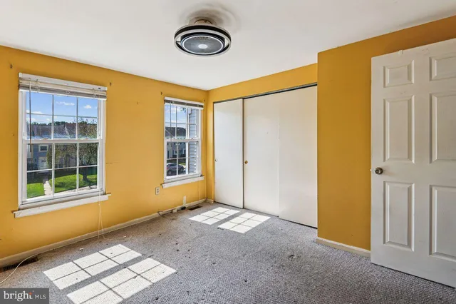 a view of a backyard with table and chairs and wooden fence