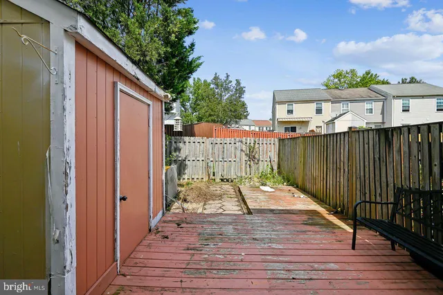 a view of a deck with wooden floor and fence