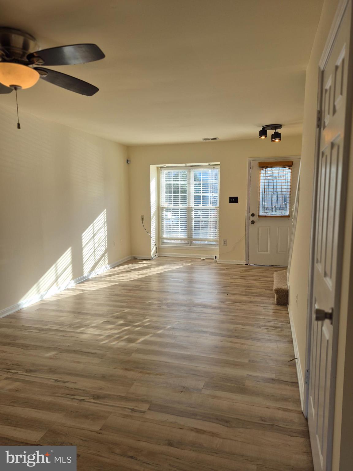 520 Bend Circle Road Glen Burnie, MD 21061 - Photo 6 of 23 a view of an empty room with window and wooden floor