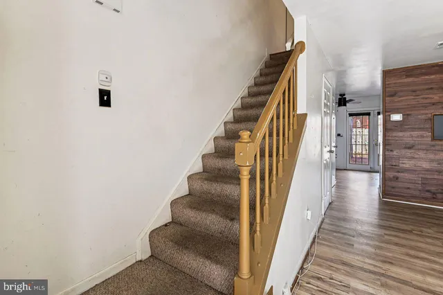 a view of a hallway with wooden floor and entryway