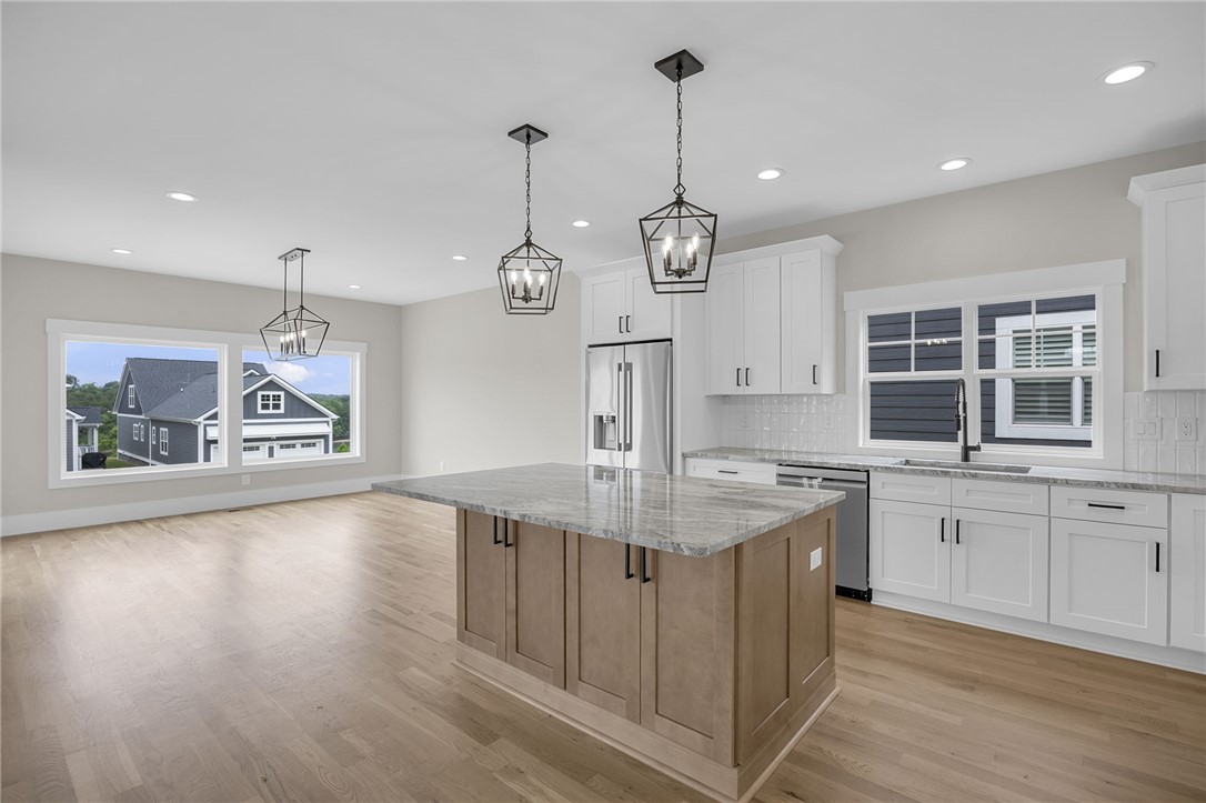 1230 Melton Road, Unit 216 West Union, SC 29696 - Photo 5 of 49 A contemporary kitchen features a spacious island with granite counters, recessed lighting, and a view of the neighborhood.