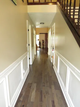 a view of a hallway with wooden floor