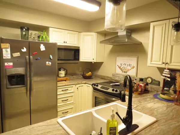 a kitchen with stainless steel appliances granite countertop a stove and a refrigerator