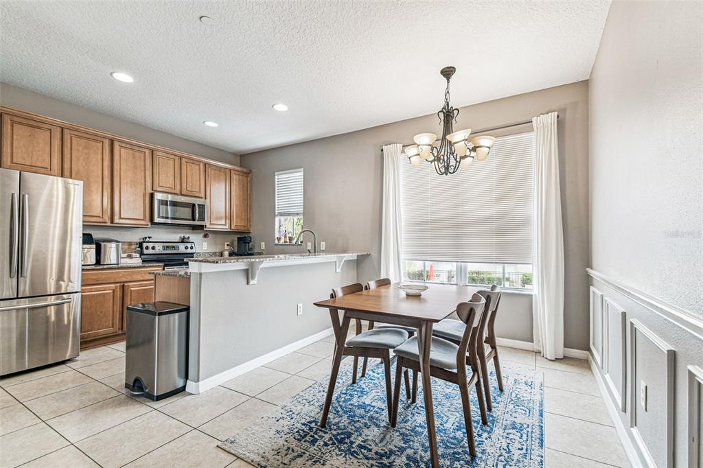 2503 Middleton Grove Drive Brandon, FL 33511 - Photo 11 of 39 a kitchen with kitchen island granite countertop a refrigerator stove microwave and cabinets