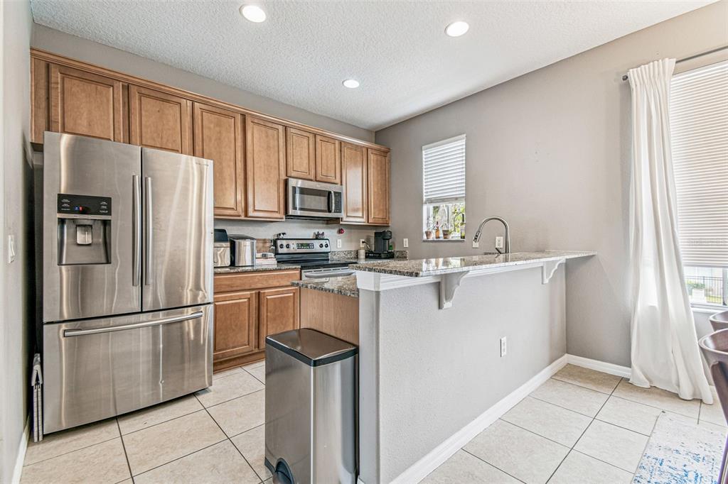 2503 Middleton Grove Drive Brandon, FL 33511 - Photo 13 of 39 a kitchen with stainless steel appliances granite countertop a refrigerator sink and microwave