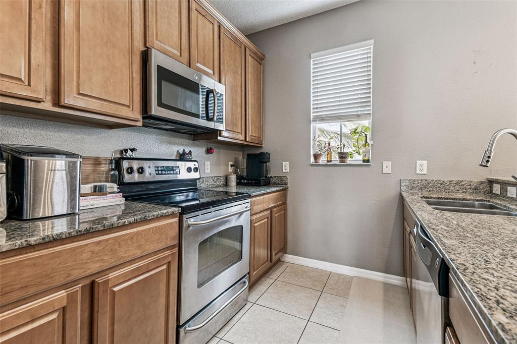 2503 Middleton Grove Drive Brandon, FL 33511 - Photo 15 of 39 a kitchen with stainless steel appliances granite countertop a sink stove and microwave