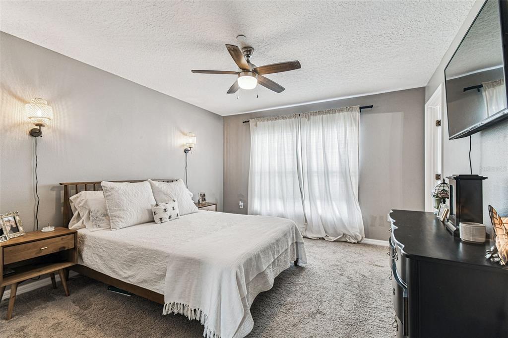 2503 Middleton Grove Drive Brandon, FL 33511 - Photo 18 of 39 a spacious bedroom with a bed and a flat screen tv