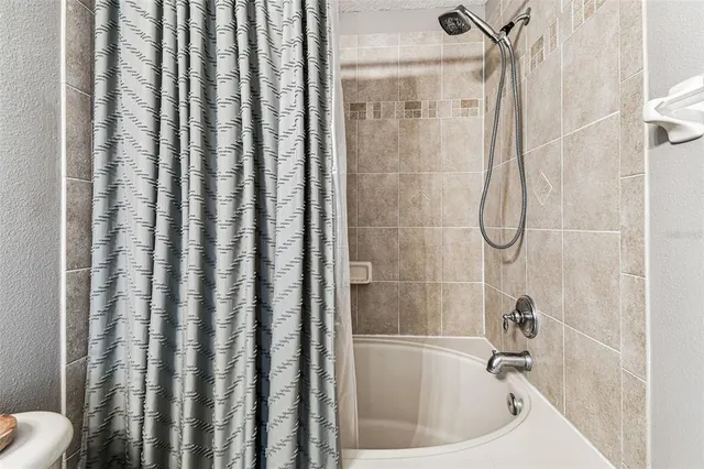 a bathroom with shower and bathtub