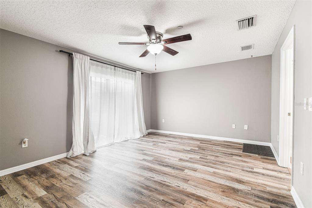 2503 Middleton Grove Drive Brandon, FL 33511 - Photo 3 of 39 a view of an empty room with window and wooden floor