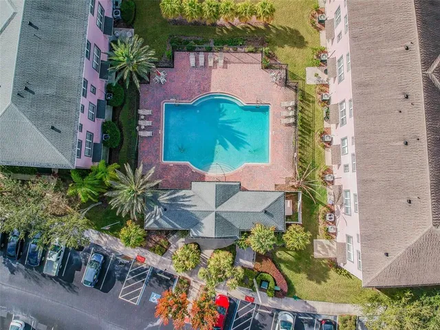an aerial view of a house with a yard and garden