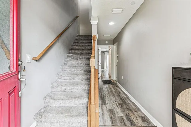 a view of entryway and hall with wooden floor