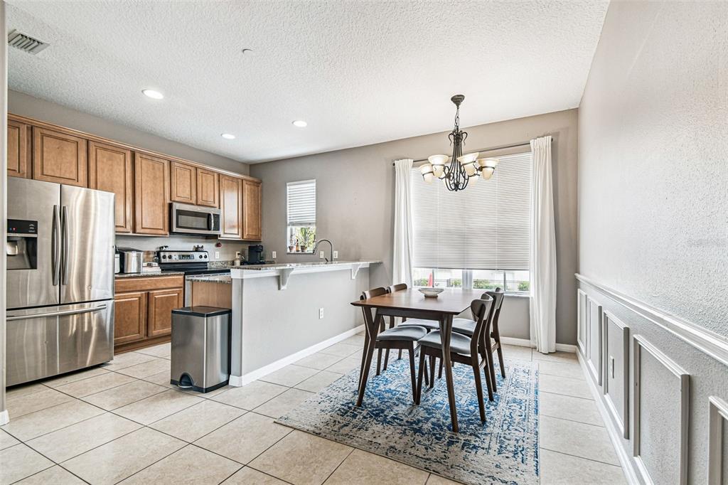 2503 Middleton Grove Drive Brandon, FL 33511 - Photo 10 of 39 a kitchen with granite countertop cabinets a counter space dining table and stainless steel appliances