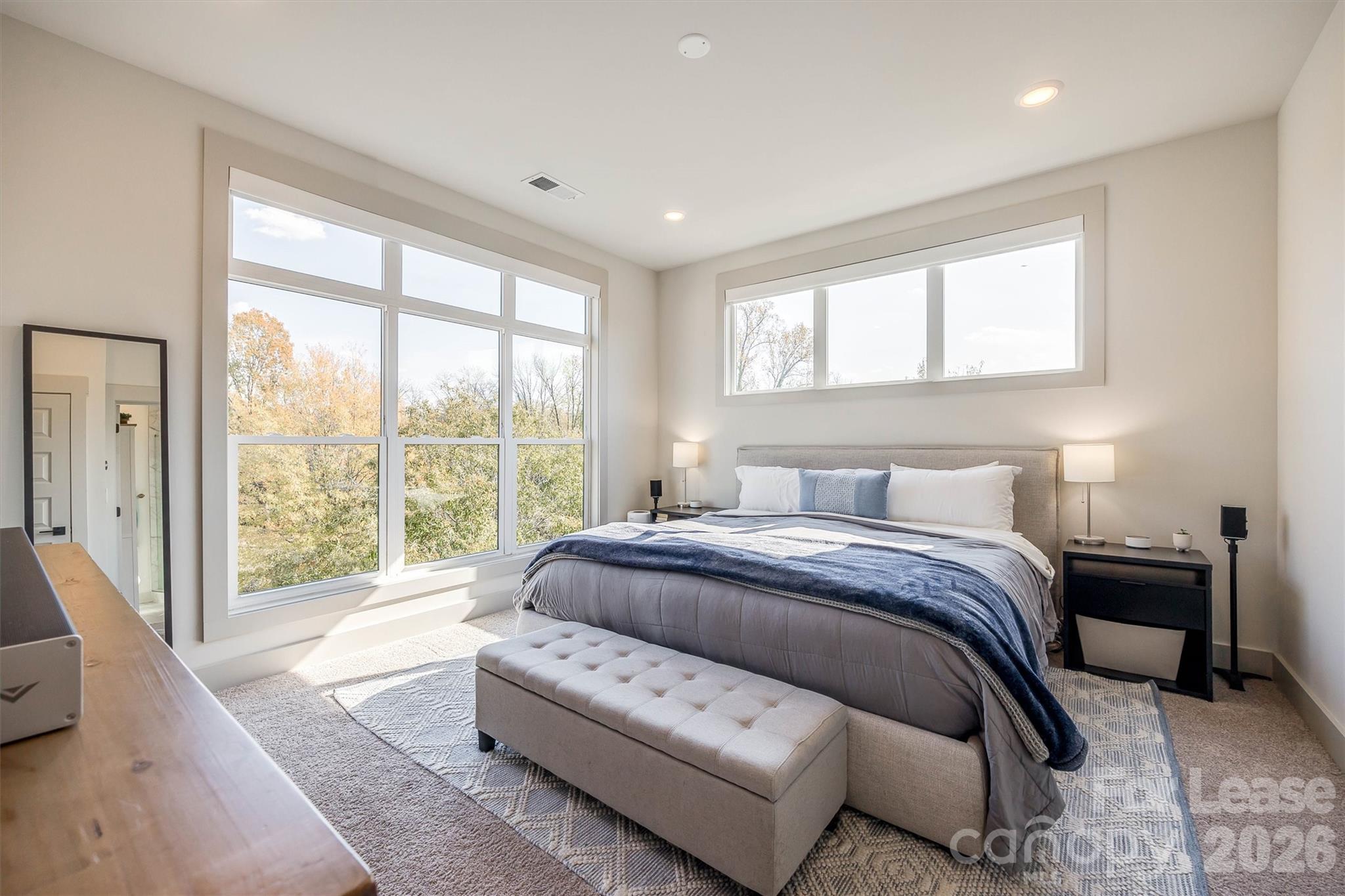 2319 Wesley Village Road Charlotte, NC 28208 - Photo 27 of 44 a spacious bedroom with a large bed and a large window