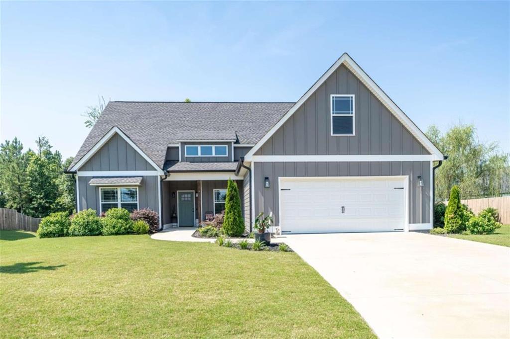 a front view of house with yard and green space