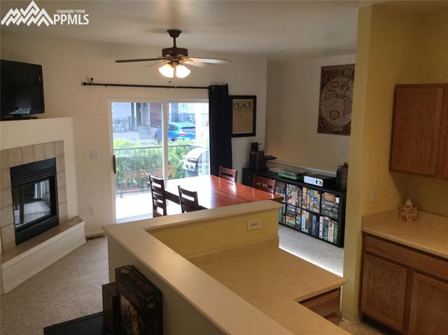 2095 Legacy Ridge View, Unit 112 Colorado Springs, CO 80910 - Photo 7 of 28 Gas fireplace on the main in the living room area.